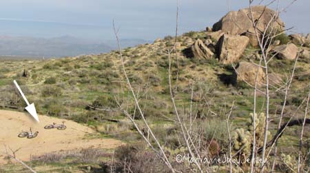 Our bikes lay in a future cul de sac while we climb.